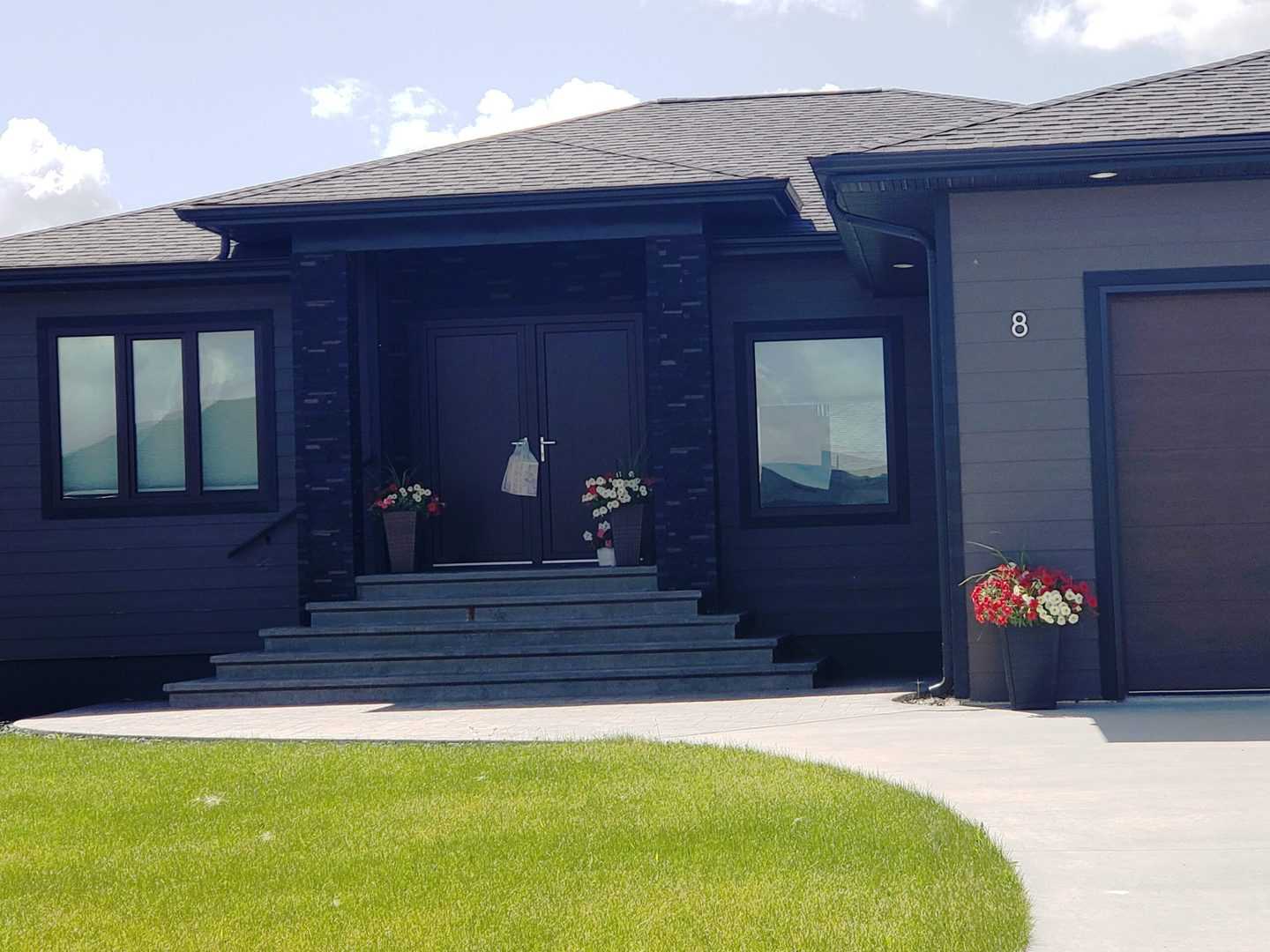 Black tilt and turn windows in a dark grey house